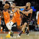 New York Knicks guard Evan Fournier (13) passes against the Phoenix Suns during the first half of an NBA basketball game, Friday, March 4, 2022, in Phoenix. (AP Photo/Matt York)
