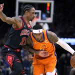 Phoenix Suns forward Torrey Craig drives on Chicago Bulls forward DeMar DeRozan (11) during the second half of an NBA basketball game Friday, March 18, 2022, in Phoenix. Phoenix won 129-102. (AP Photo/Rick Scuteri)