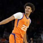 Phoenix Suns forward Cameron Johnson (23) smiles after a three pointer against the New York Knicks during the second half of an NBA basketball game, Friday, March 4, 2022, in Phoenix. The Phoenix Suns defeated the Knicks 115-114. (AP Photo/Matt York)
