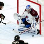 Colorado Avalanche goaltender Pavel Francouz (39) makes the save on a shot by Arizona Coyotes defenseman Vladislav Kolyachonok (92) as Coyotes defenseman Jakob Chychrun (6) watches during the third period of an NHL hockey game Thursday, March 3, 2022, in Glendale, Ariz. The Coyotes won 2-1. (AP Photo/Ross D. Franklin)