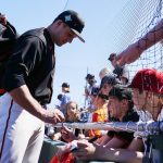 San Francisco Giants' Jason Vosler signs autographs for fans prior to a spring training baseball game against the Arizona Diamondbacks Wednesday, March 23, 2022, in Scottsdale, Ariz. (AP Photo/Ross D. Franklin)