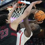 Stanford's Brandon Angel (23) fouls Arizona's Bennedict Mathurin (0) during the second half of an NCAA college basketball game in the quarterfinal round of the Pac-12 tournament Thursday, March 10, 2022, in Las Vegas. (AP Photo/John Locher)
