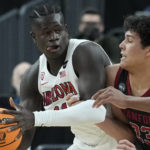 Stanford's Brandon Angel (23) guards Arizona's Oumar Ballo (11) during the first half of an NCAA college basketball game in the quarterfinal round of the Pac-12 tournament Thursday, March 10, 2022, in Las Vegas. (AP Photo/John Locher)