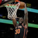 New York Knicks forward Julius Randle (30) duns against the Phoenix Suns during the first half of an NBA basketball game, Friday, March 4, 2022, in Phoenix. (AP Photo/Matt York)