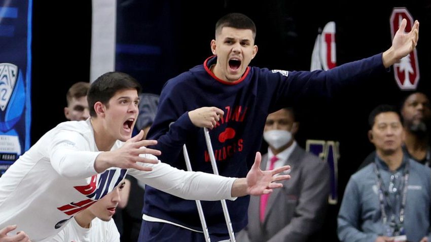 Kerr Kriisa #25 of the Arizona Wildcats uses a crutch as he reacts on the bench during the Pac-12 C...
