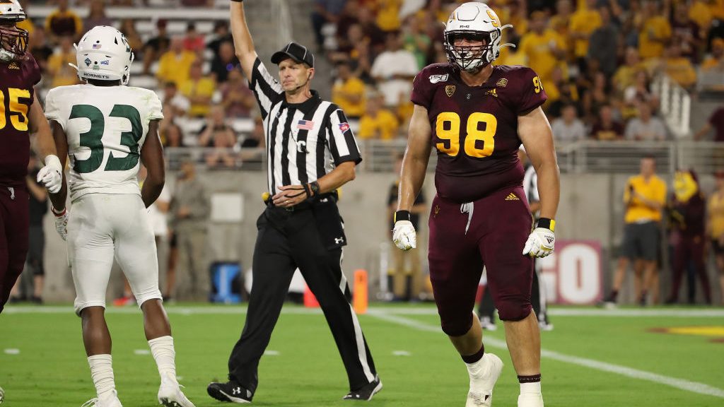 Defensive lineman D.J. Davidson #98 of the Arizona State Sun Devils reacts after a defensive stop a...