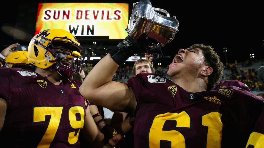 Offensive lineman Dohnovan West #61 of the Arizona State Sun Devils celebrates with the Territorial...
