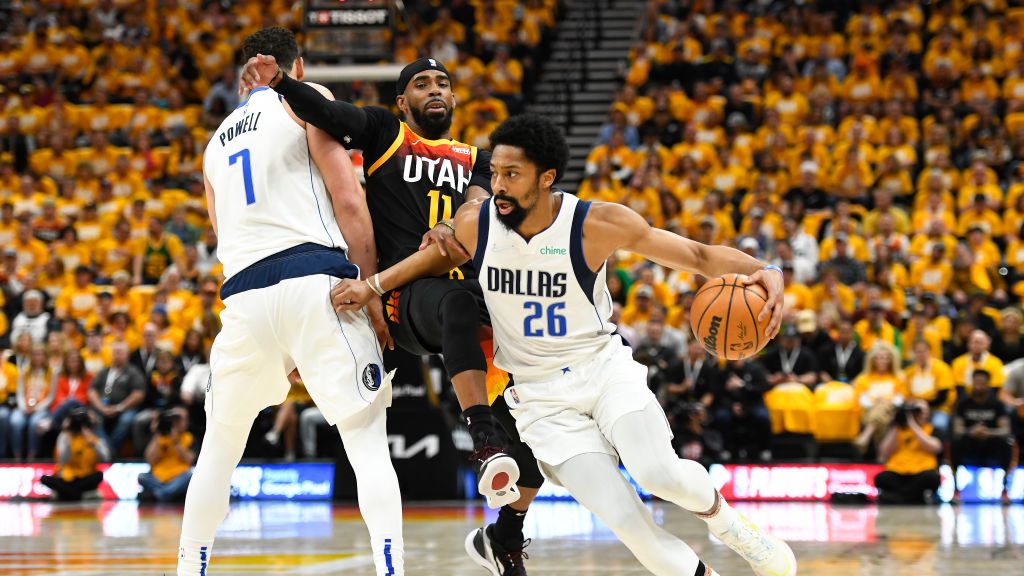 Spencer Dinwiddie #26 of the Dallas Mavericks drives around Mike Conley #11 of the Utah Jazz during...