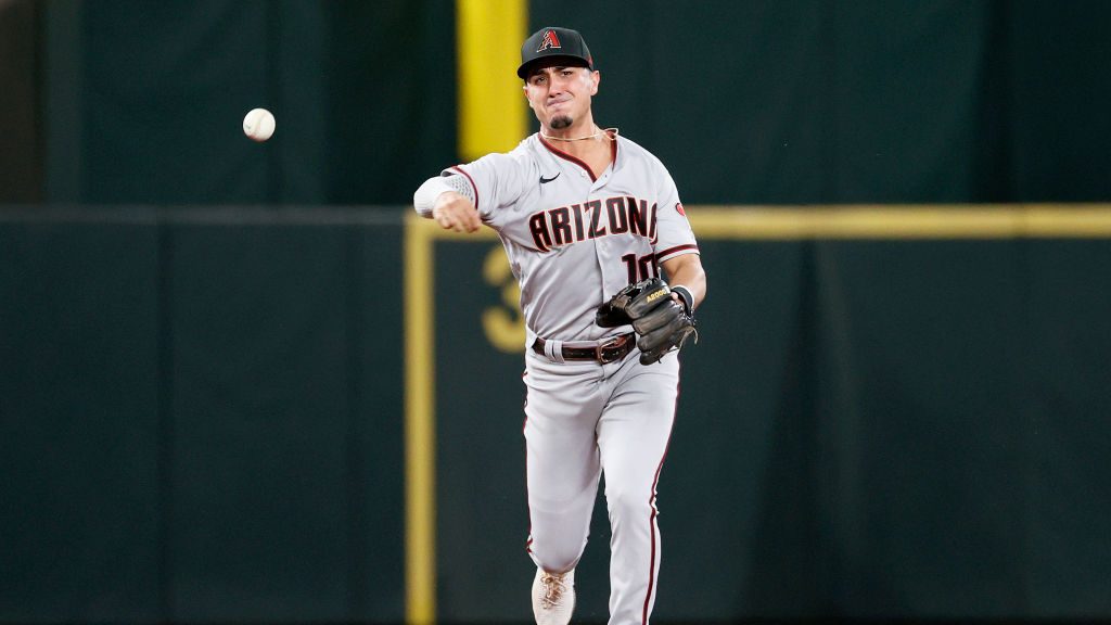 Josh Rojas #10 of the Arizona Diamondbacks throws to first base against the Seattle Mariners at T-M...