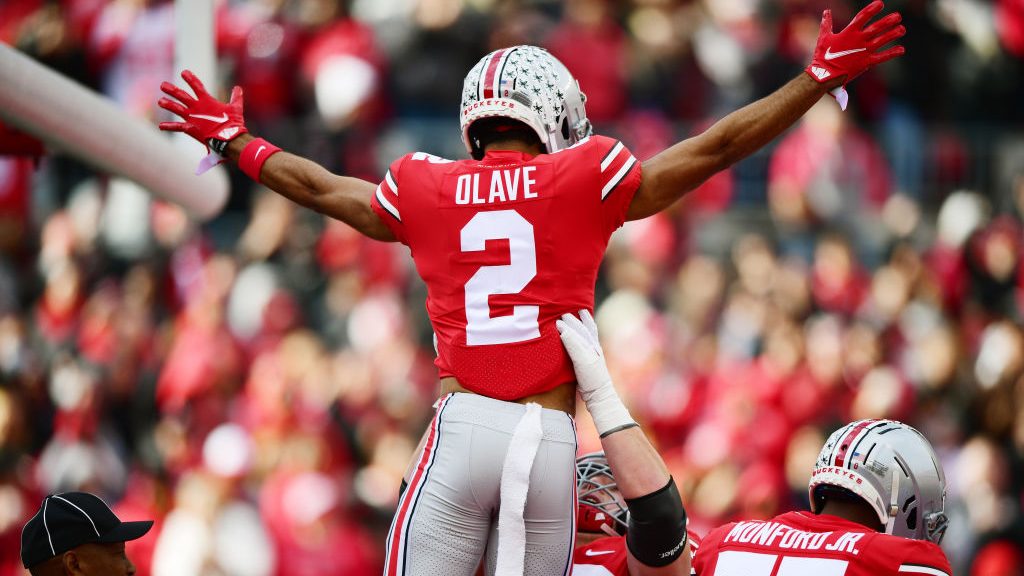 Chris Olave #2 of the Ohio State Buckeyes celebrates with teammates after a touchdown during the fi...