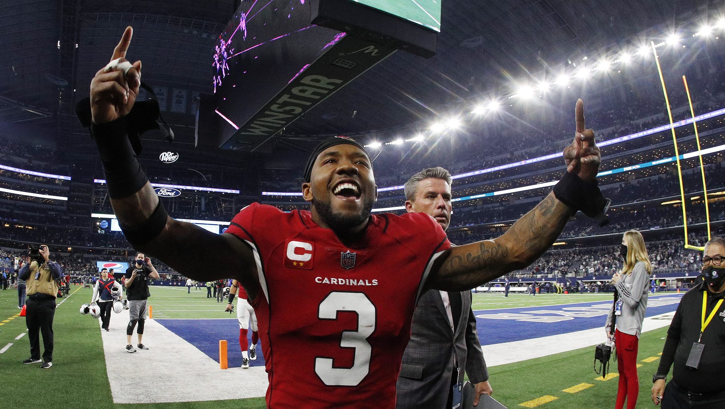 Budda Baker #3 of the Arizona Cardinals celebrates as he runs off the field after defeating the Dal...