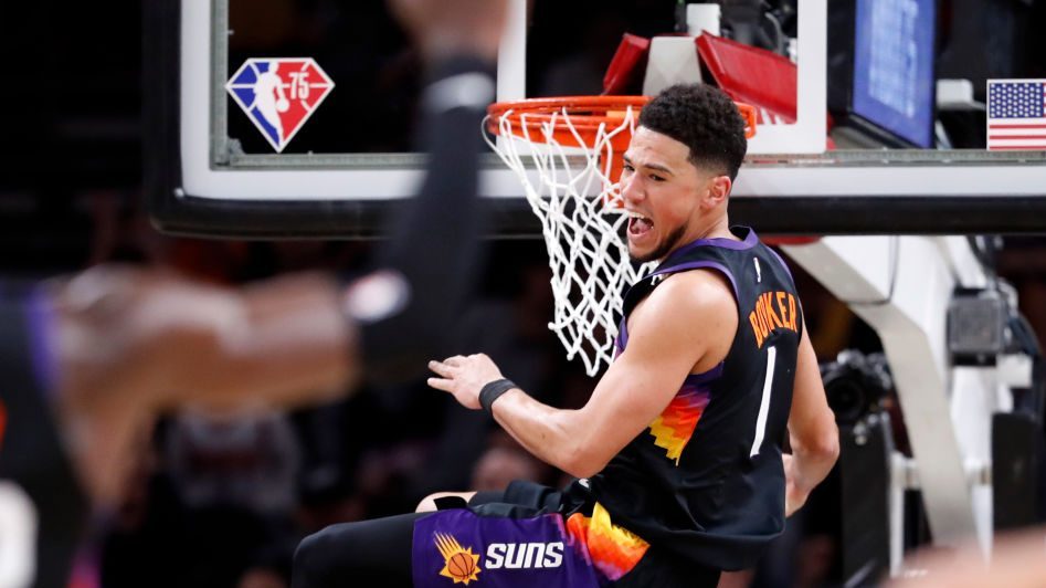 Devin Booker #1 of the Phoenix Suns reacts after dunking the ball during the first half against the...