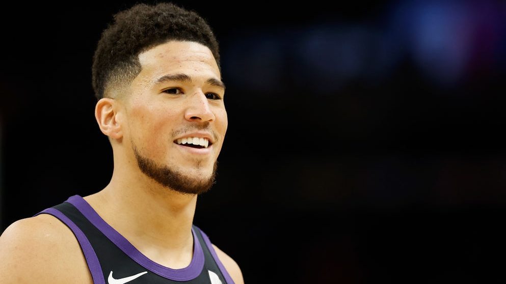 Devin Booker #1 of the Phoenix Suns reacts during the first half of the NBA game against the Philad...