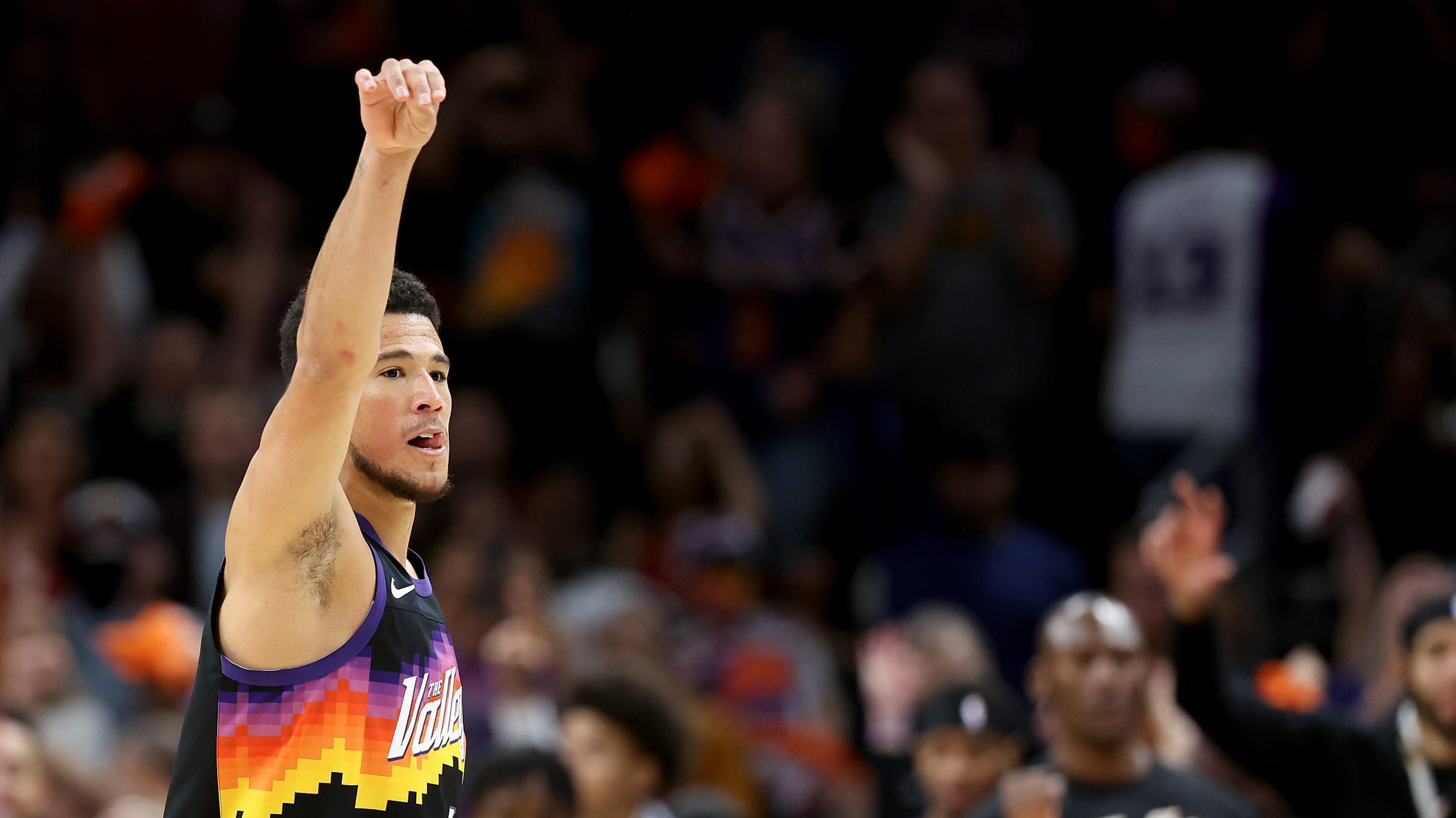 Devin Booker #1 of the Phoenix Suns reacts after a three-point shot against the New Orleans Pelican...