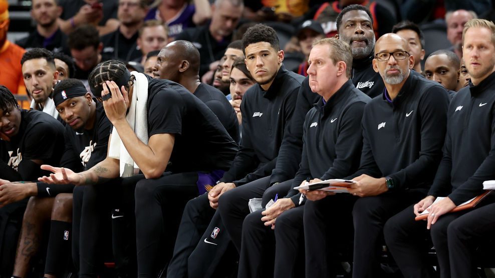 Devin Booker #1 of the Phoenix Suns watches from the bench during the second half of Game Two of th...
