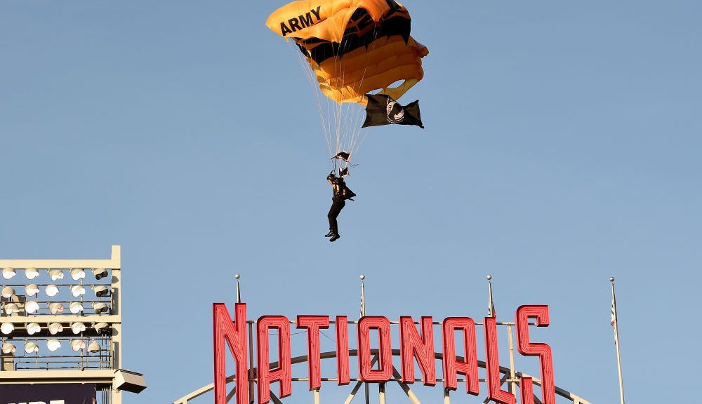 A member of the US Army Parachute Team The Golden Knights lands at Nationals Park before the game b...