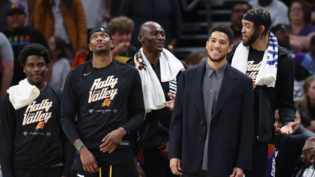 Devin Booker #1 of the Phoenix Suns reacts from the bench during the first half of Game Five of the...