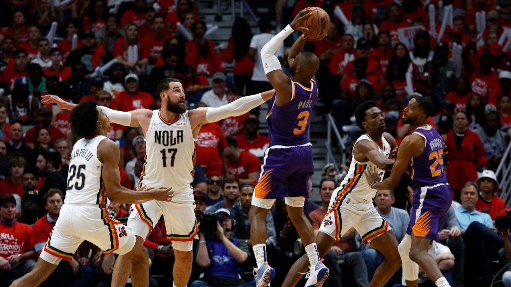 Chris Paul #3 of the Phoenix Suns shoots the ball over Jonas Valanciunas #17 of the New Orleans Pel...