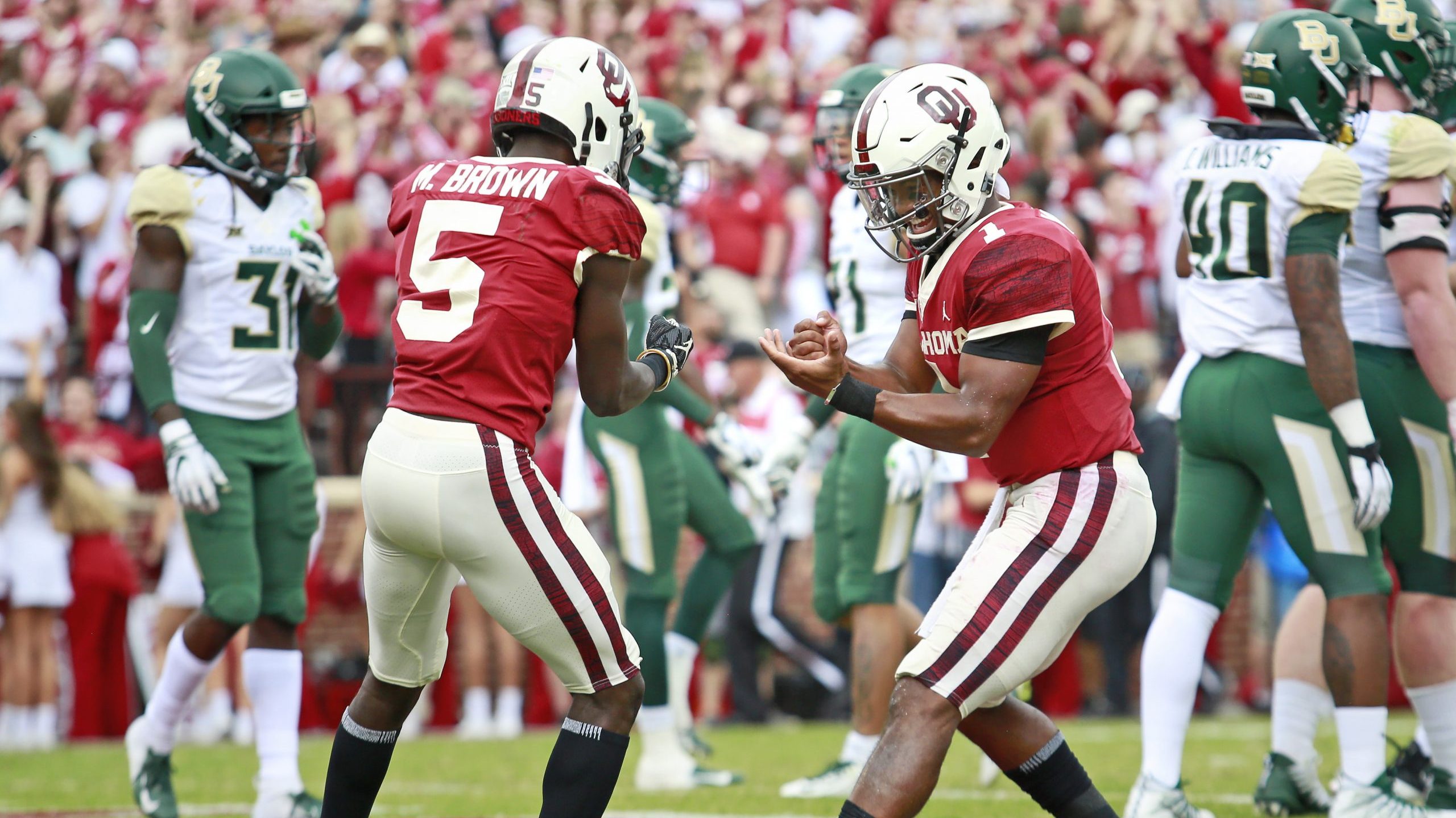 Quarterback Kyler Murray #1 and wide receiver Marquise Brown #5 of the Oklahoma Sooners celebrate a...
