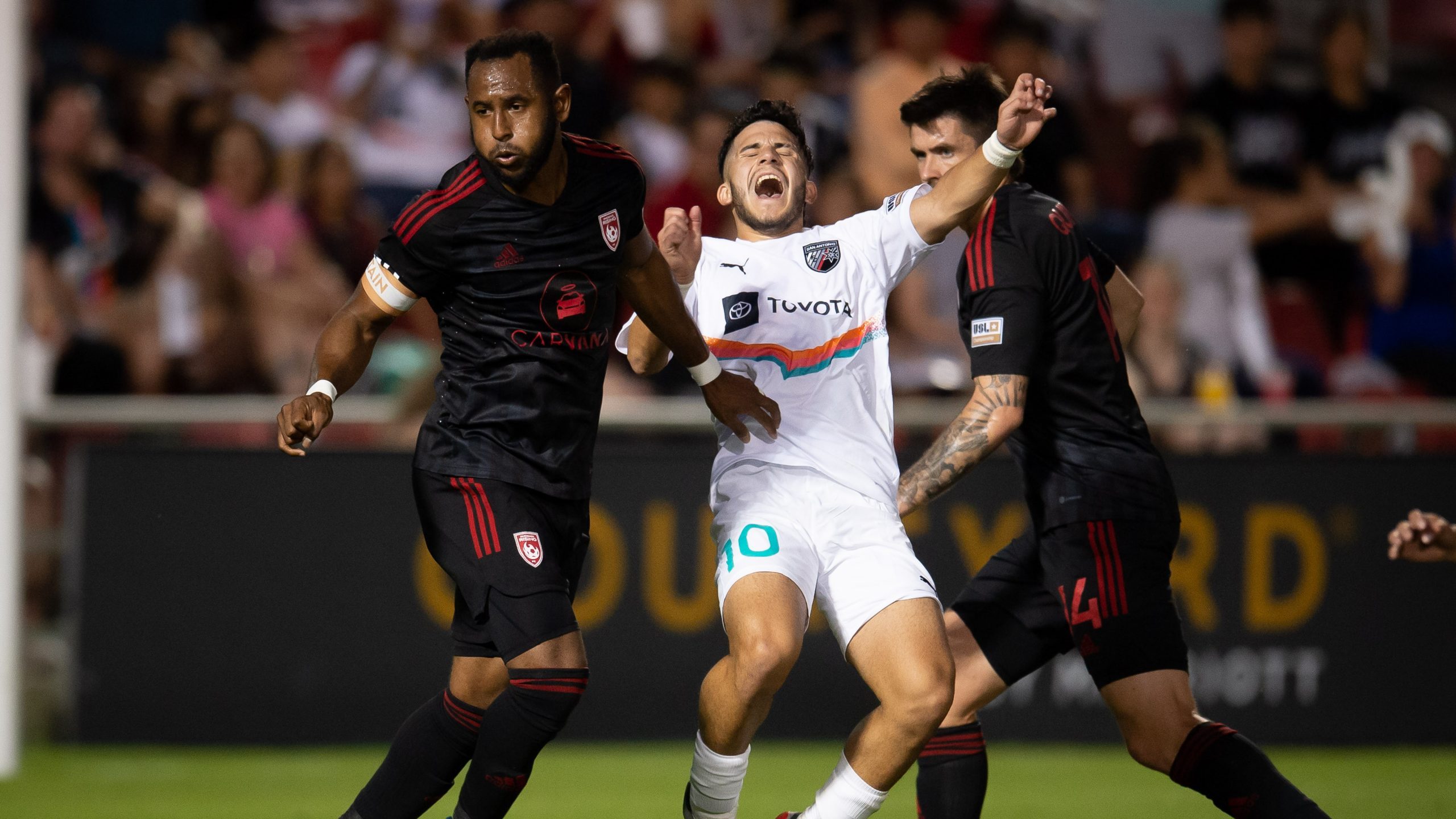 Phoenix Rising FC captain Darnell Kings (left) and SAFC midfielder David Loera (right) play in a 2-...