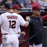 Arizona Diamondbacks center fielder Daulton Varsho (12) greets manager Torey Lovullo after scoring on a fielders choice by Christian Walker during the first inning of a baseball game against the New York Mets, Saturday, April 23, 2022, in Phoenix. (AP Photo/Matt York)