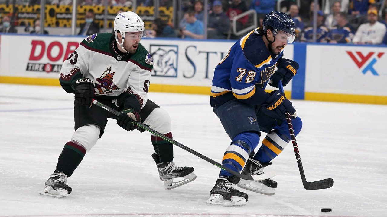 St. Louis Blues' Justin Faulk (72) brings the puck down the ice as Arizona Coyotes' Michael Carcone...