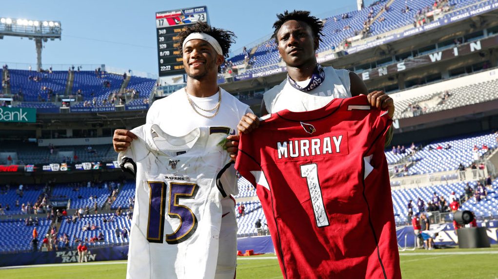 Wide Receiver Marquise Brown #15 of the Baltimore Ravens trades jerseys with quarterback Kyler Murr...