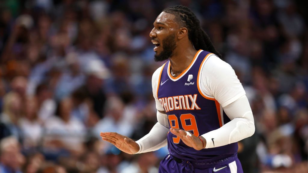 Jae Crowder #99 of the Phoenix Suns reacts toward the Mavericks bench after scoring with a three po...