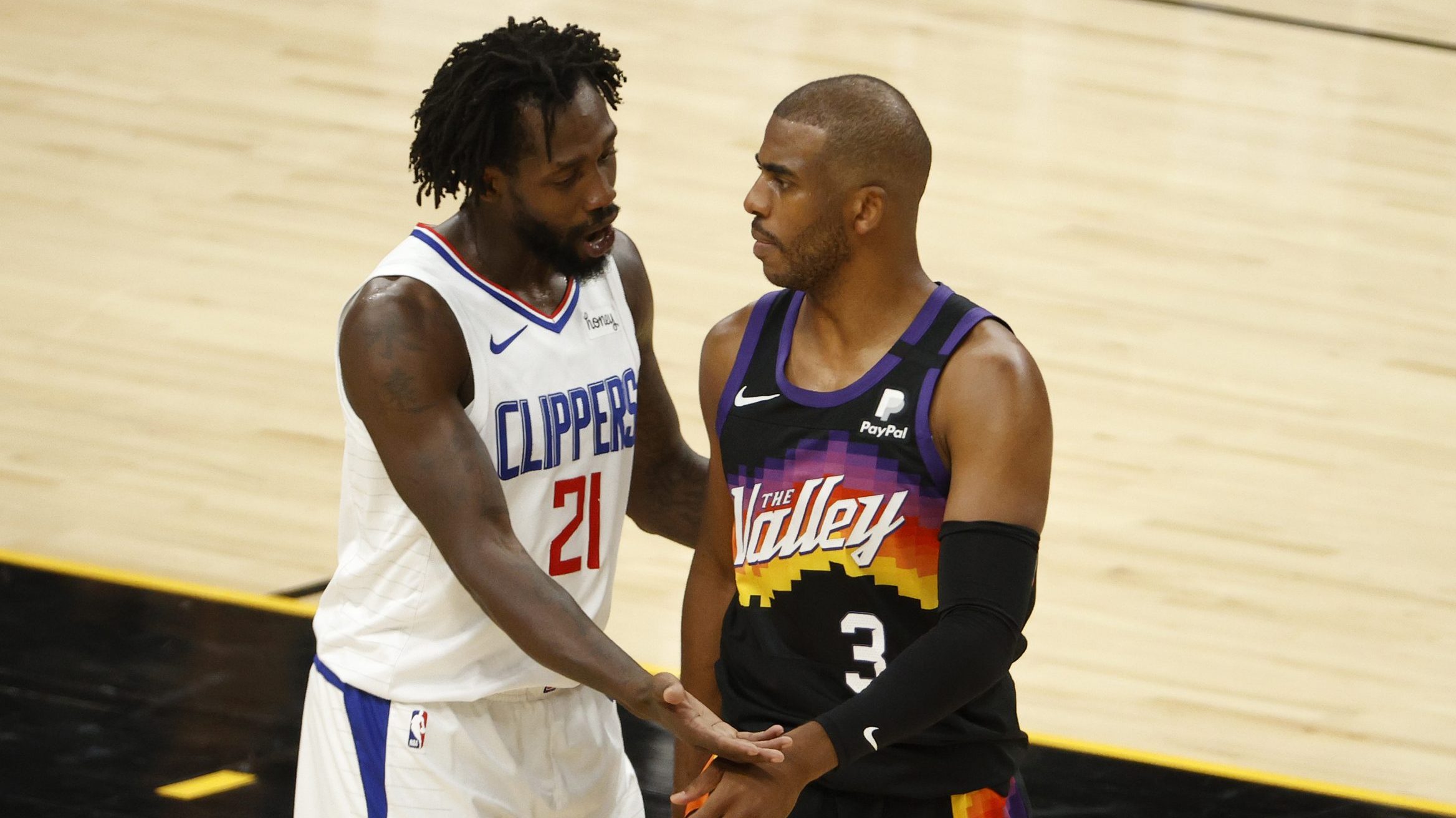 Patrick Beverley #21 of the LA Clippers talks with Chris Paul #3 of the Phoenix Suns after a foul d...