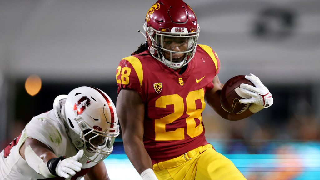 Keaontay Ingram #28 of the USC Trojans runs as he is chased by Ricky Miezan #45 of the Stanford Car...