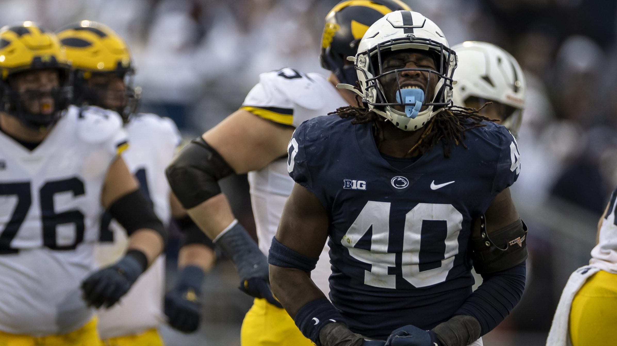 Jesse Luketa #40 of the Penn State Nittany Lions celebrates after a play against the Michigan Wolve...