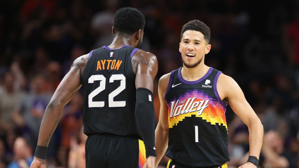 Devin Booker #1 of the Phoenix Suns celebrates with Deandre Ayton #22 during the first half of Game...