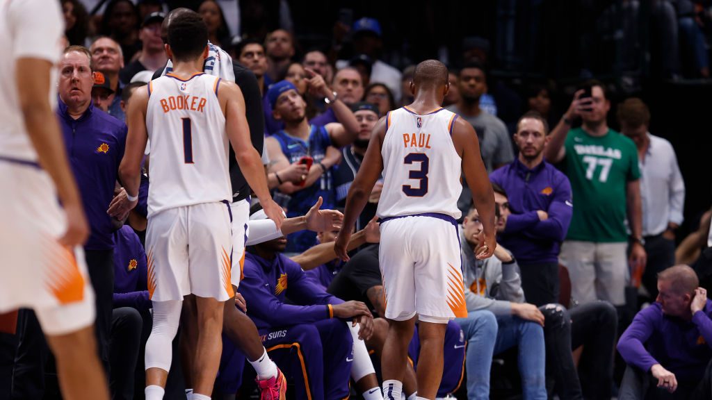 Chris Paul #3 of the Phoenix Suns and Devin Booker #1 of the Phoenix Suns walk off the court while ...