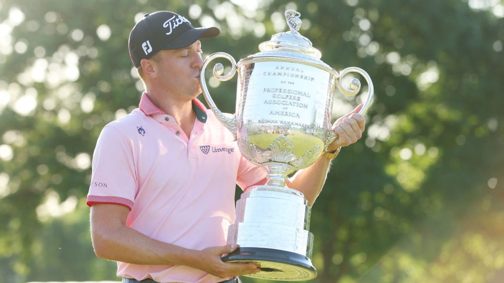 Justin Thomas of the United States poses with the Wanamaker Trophy after putting in to win on the 1...