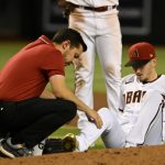 Assistant athletic trainer Ryne Eubanks of the Arizona Diamondbacks looks at pitcher Zach Davies #27 after being hit with a line drive by Bobby Witt Jr #7 of the Kansas City Royals during the fourth inning at Chase Field on May 23, 2022 in Phoenix, Arizona. Witt Jr was safe at first base. (Photo by Norm Hall/Getty Images)