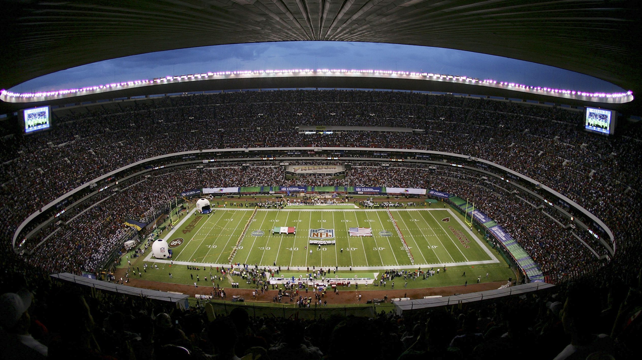 The American and Mexican flags are displayed on the field during the pre-game ceremony before the g...