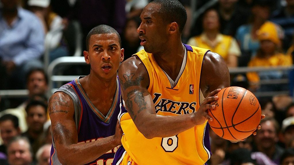 Kobe Bryant #8 of the Los Angeles Lakers looks to pass against Raja Bell #19 0f the Phoenix Suns in...