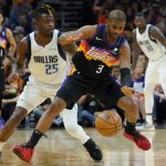 Phoenix Suns guard Chris Paul (3) works the ball past Dallas Mavericks forward Reggie Bullock (25) during the first half of Game 2 in the second round of the NBA Western Conference playoff series Wednesday, May 4, 2022, in Phoenix. (AP Photo/Matt York)
