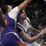 Dallas Mavericks guard Luka Doncic, right, drives to the basket against Phoenix Suns center JaVale McGee, left, during the second half of Game 3 of an NBA basketball second-round playoff series, Friday, May 6, 2022, in Dallas. (AP Photo/Tony Gutierrez)