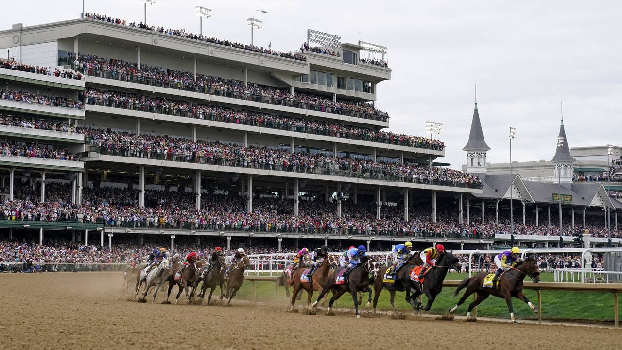 Horses come through the first turn during the 148th running of the Kentucky Derby horse race at Chu...