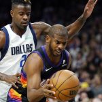Phoenix Suns guard Chris Paul, right, grabs a rebound in front of Dallas Mavericks forward Reggie Bullock, left, during the first half of Game 5 of an NBA basketball second-round playoff series Tuesday, May 10, 2022, in Phoenix. (AP Photo/Ross D. Franklin)