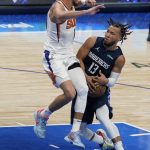 Dallas Mavericks guard Jalen Brunson (13) drives to the basket against Phoenix Suns guard Devin Booker, left, during the second half of Game 6 of an NBA basketball second-round playoff series, Thursday, May 12, 2022, in Dallas. (AP Photo/Tony Gutierrez)