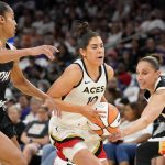 Las Vegas Aces' Kelsey Plum (10) drives to the basket between Phoenix Mercury's Skyler Diggins-Smith, left, and Diana Taurasi, right, during the first half of a WNBA basketball game Friday, May 6, 2022, in Phoenix. (AP Photo/Darryl Webb)
