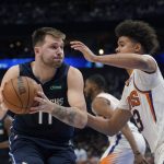 Dallas Mavericks guard Luka Doncic, left, is pressured by Phoenix Suns forward Cameron Johnson, right, during the second half of Game 6 of an NBA basketball second-round playoff series, Thursday, May 12, 2022, in Dallas. (AP Photo/Tony Gutierrez)