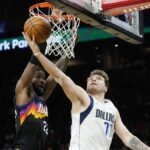 Dallas Mavericks guard Luka Doncic (77) tries to get off a shot against Phoenix Suns center Deandre Ayton (22) during the first half of Game 5 of an NBA basketball second-round playoff series Tuesday, May 10, 2022, in Phoenix. (AP Photo/Ross D. Franklin)