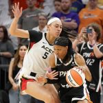 Phoenix Mercury's Shey Peddy, front right, drives around Las Vegas Aces' Dearica Hamby (5) during the first half of their game Friday, May 6, 2022, in Phoenix. (AP Photo/Darryl Webb)