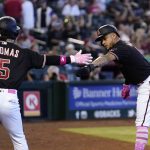 Arizona Diamondbacks' Ketel Marte, right, celebrates his run scored against the Colorado Rockies with teammate Alek Thomas (5) in the second inning of a baseball game Sunday, May 8, 2022, in Phoenix. (AP Photo/Ross D. Franklin)