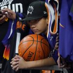 A fan waits for autographs before Game 2 in the second round of the NBA Western Conference playoff series between the Dallas Mavericks and the Phoenix Suns to begin, Wednesday, May 4, 2022, in Phoenix. (AP Photo/Matt York)