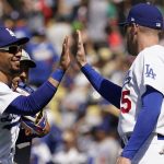 Los Angeles Dodgers' Mookie Betts, left, celebrates a win over the Arizona Diamondbacks with Freddie Freeman in the first game of a baseball double-header Tuesday, May 17, 2022, in Los Angeles. (AP Photo/Marcio Jose Sanchez)