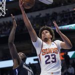 Phoenix Suns forward Cameron Johnson (23) drives to the basket against Dallas Mavericks forward Dorian Finney-Smith (10) during the first half of Game 6 of an NBA basketball second-round playoff series, Thursday, May 12, 2022, in Dallas. (AP Photo/Tony Gutierrez)